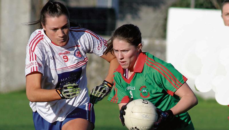 St Brendan's captain Nora Ward secures possession ahead of Clontarf's Niamh Hetherton during Sunday's All-Ireland Club Intermediate ladies football semi-final at Duggan Park. Photo: Mike O'Hehir.