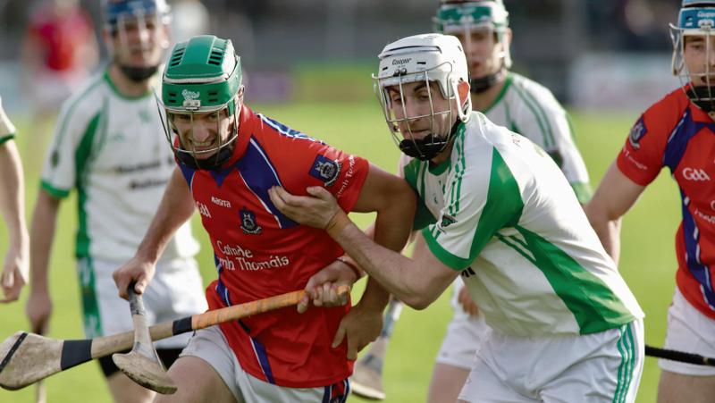 St Thomas' David Burke tussling for possession with Sarsfields' Niall Morrissey during Sunday's senior hurling semi final at Kenny Park. Photos: Brian Harding.