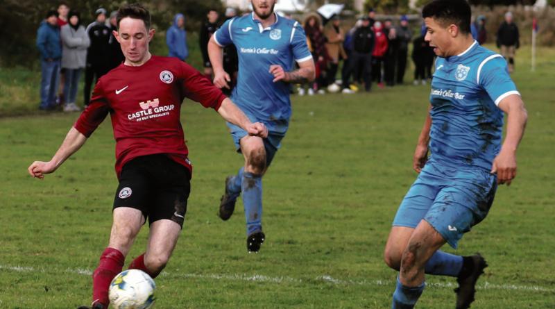 Athenry defender Gary O'Connell about to cross the ball against John Donnellan and Aaron Lawrence of Dynamo Blues in Tuam on Sunday. Photo: EIREFOTO.