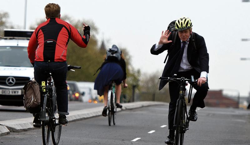 On yer bike: A frank exchange of views via sign language as Boris Johnson gets a less than complimentary greeting from a fellow cyclist on the streets of London.