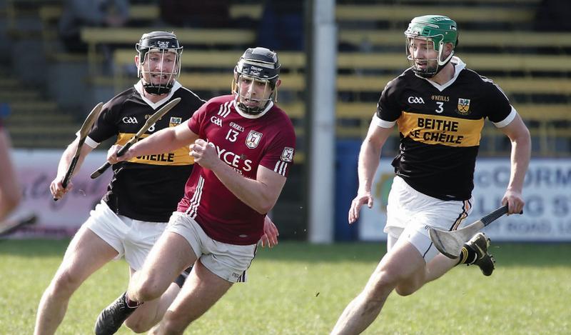 Athenry's Martin Cullen breaking away from Beagh's Thomas McKeown and Adrian Touhey during Saturday's senior hurling championship clash in Loughrea. Photos: Joe O'Shaughnessy.