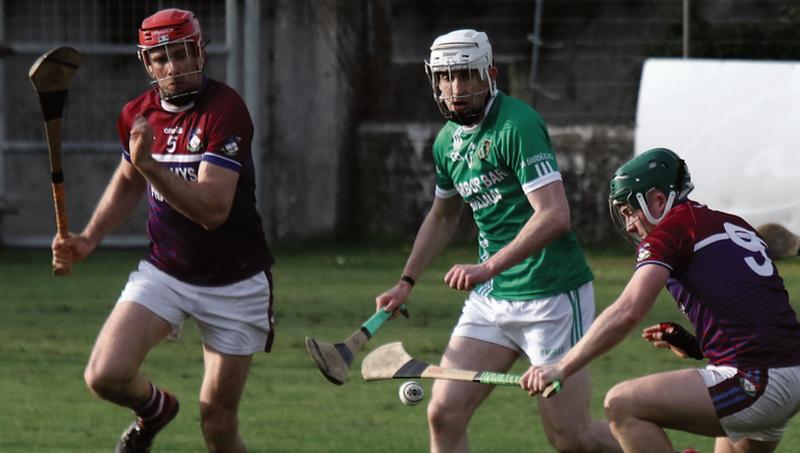 Kilnadeema/Leitrim's Alvin Mitchell and Tom Tierney outnumber Niall Morrisey of Sarsfields during this tussle for possession in Saturday's senior A hurling championship tie at Duggan Parkl. Photos: Joe Keane.