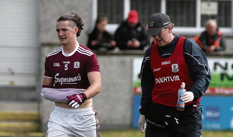 Galway defender Kieran Molloy departs the field with a suspected disclocated shoulder in Sunday's Connacht championship semi-final against Sligo at Maerkivicz Park. On right is team doctor Enda Devitt. Photo: Joe O'Shaughnessy.