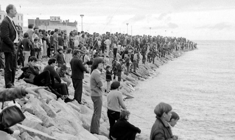 Crowds throng the rocks off Salthill Prom to watch amateur anglers in their dozens fishing for mackerel in August 1971.