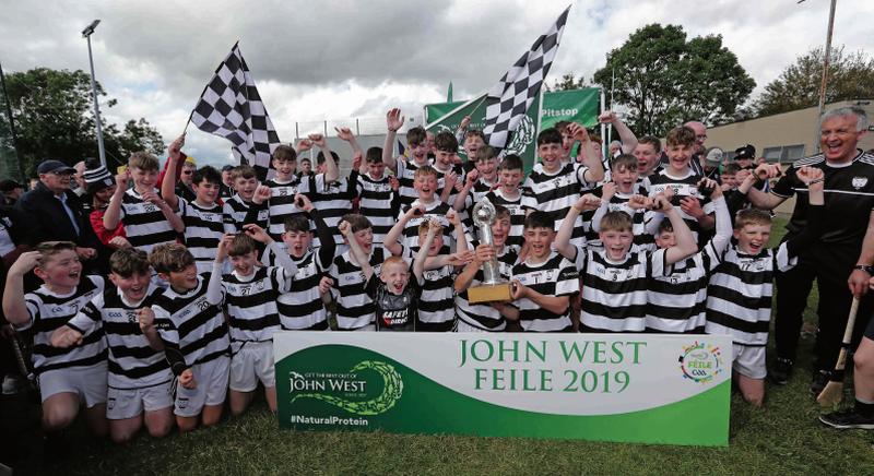 Turloughmore players celebrate their victory in the John West Feile na nGael Division 1 final at St Finbarr's Togher, Cork on Sunday after overcoming Na Piarsaigh in the decider. Photos: Jim Coughlan.